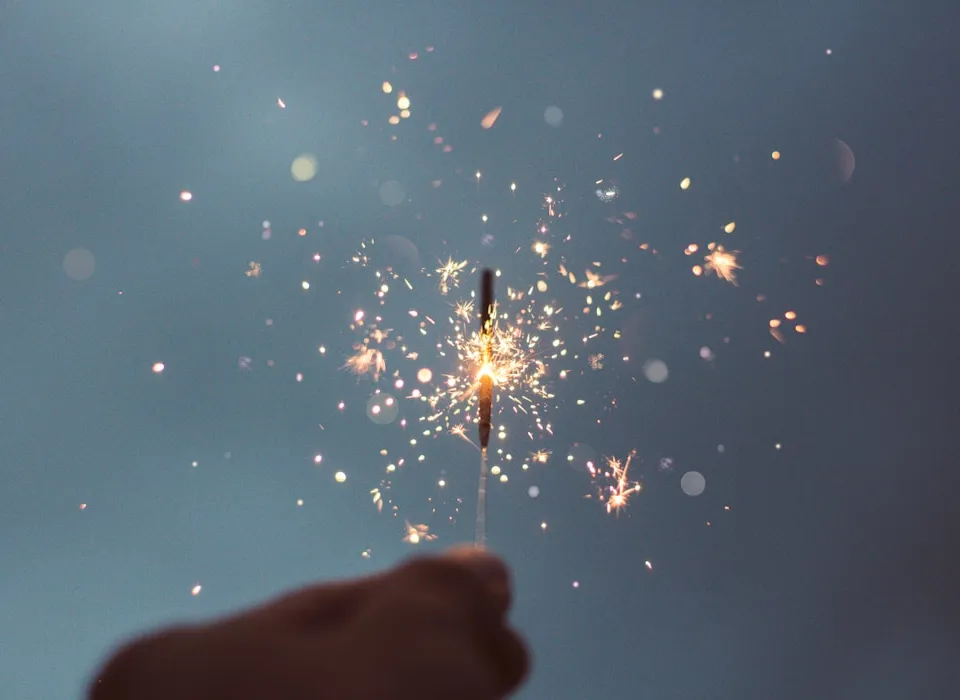person holding lighted sparklers