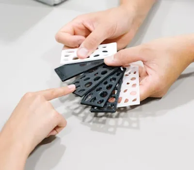 person holding black and white polka dot print textile
