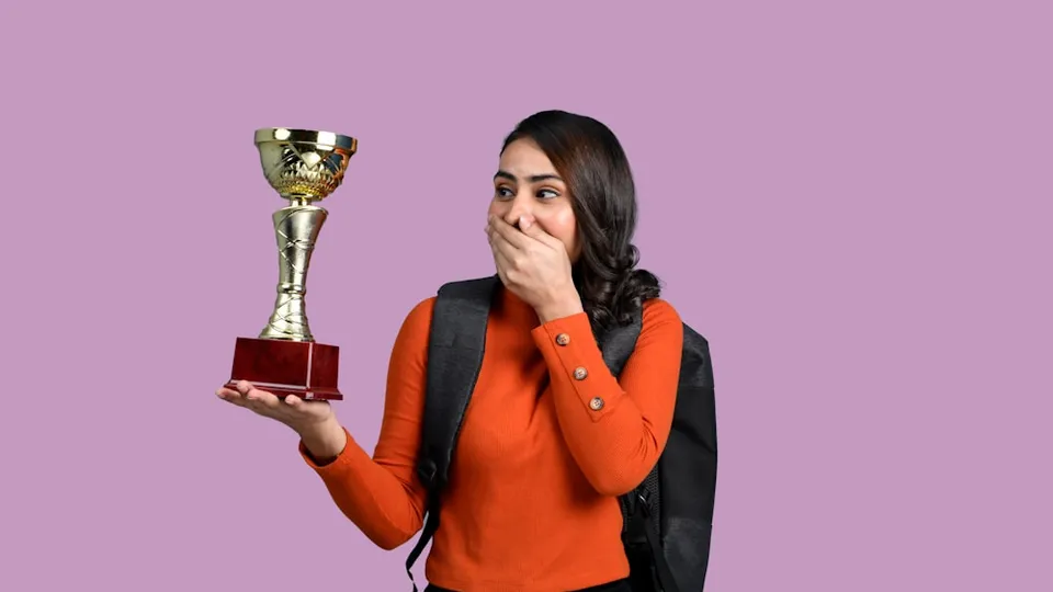 a woman holding a trophy